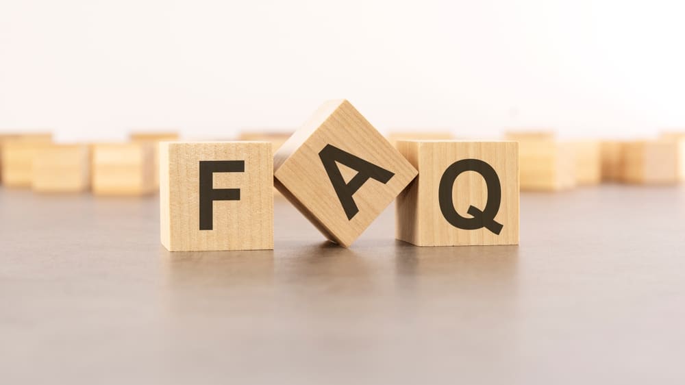 Wooden blocks forming the letters ‘FAQ,’ symbolising a frequently asked questions section about Wood Floor Sanding in Kent.