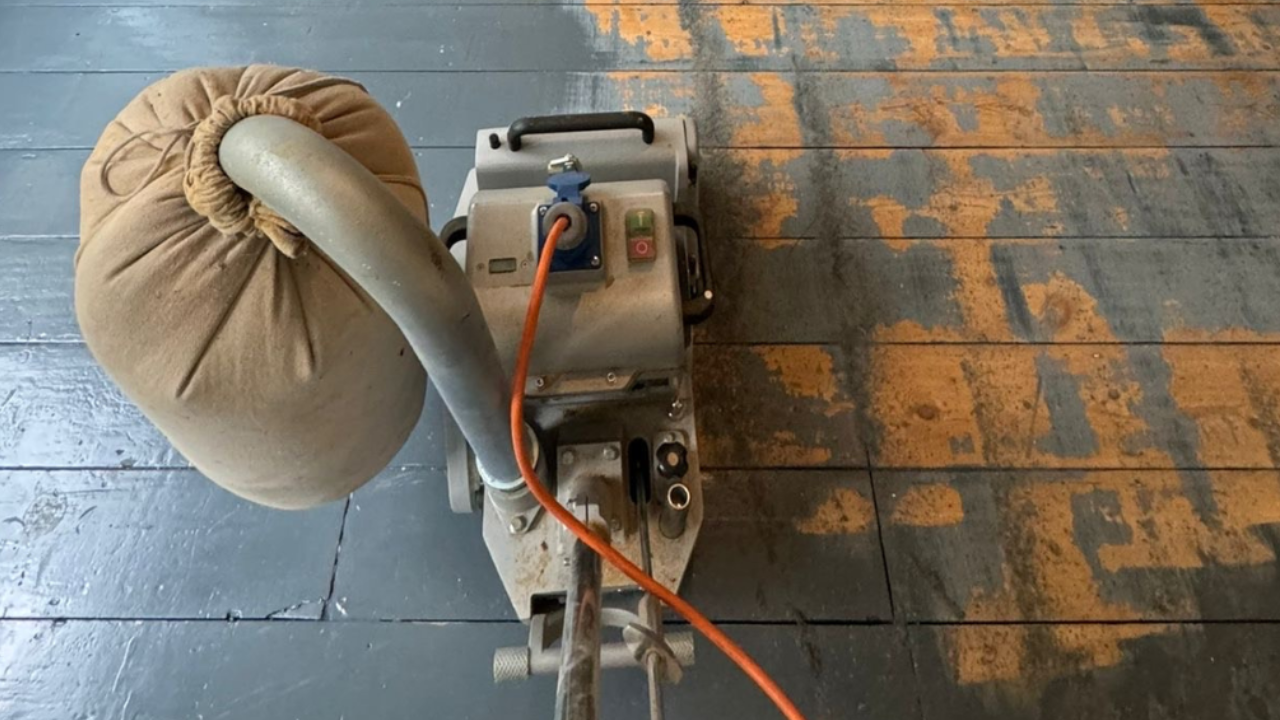 A professional floor sanding machine stripping away layers of old paint during Wood Floor Sanding in Kent.