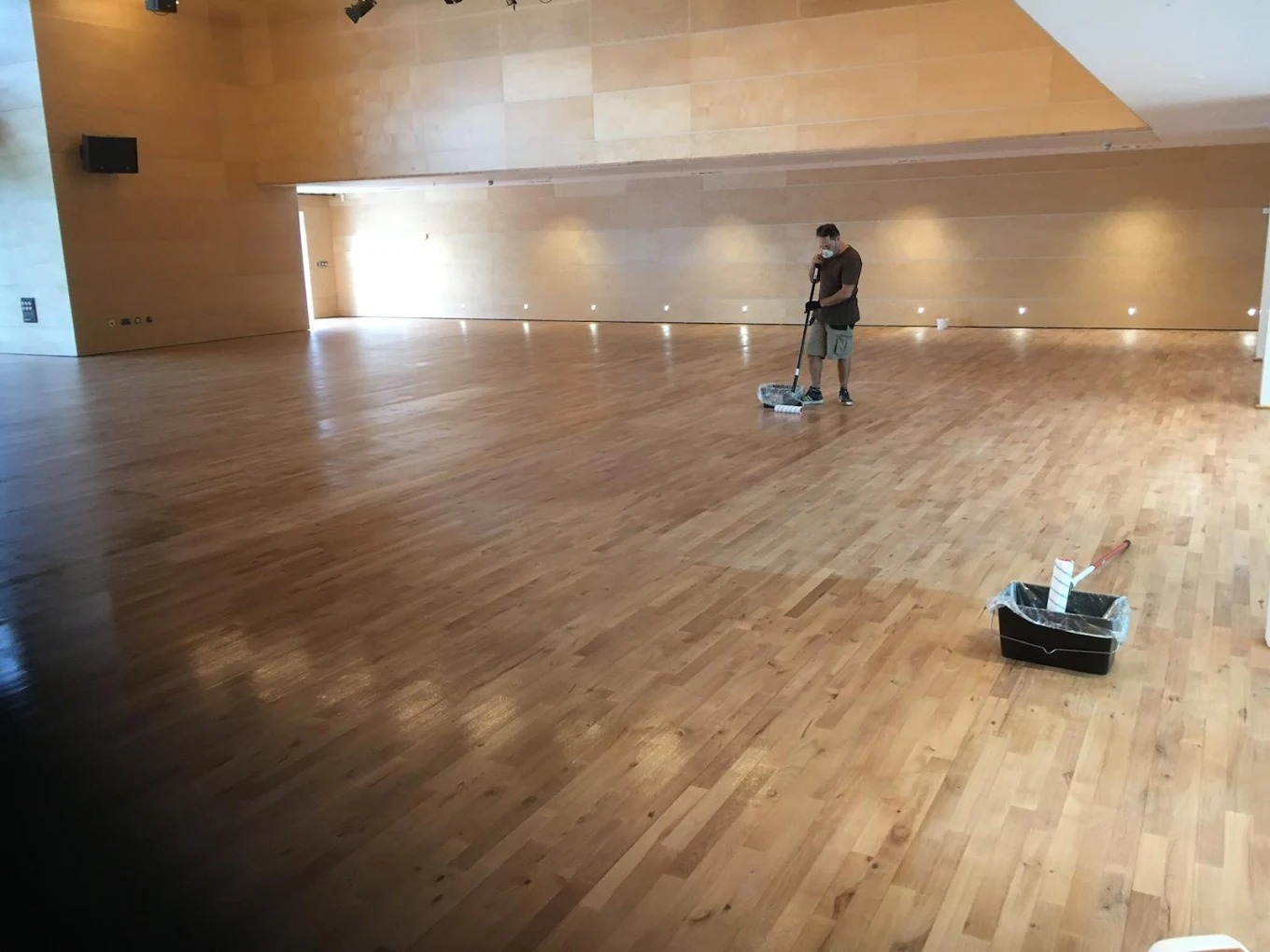 Commercial Oiling in Kent – large beech hardwood floor in a hall being oiled by a professional for a smooth, durable finish.