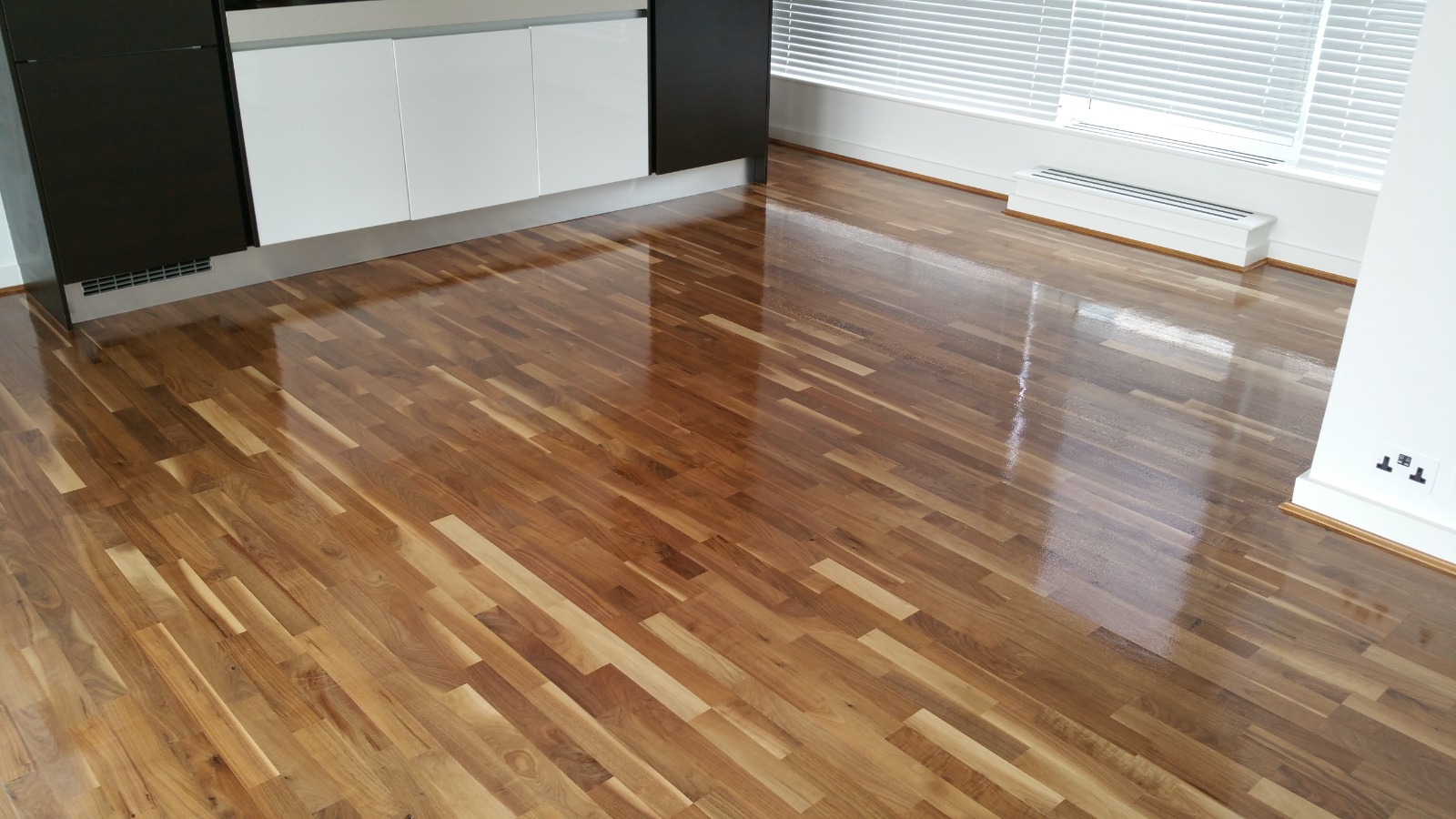 Commercial Oiling in Kent – walnut engineered strip hardwood floor finished to a rich, high-gloss sheen.