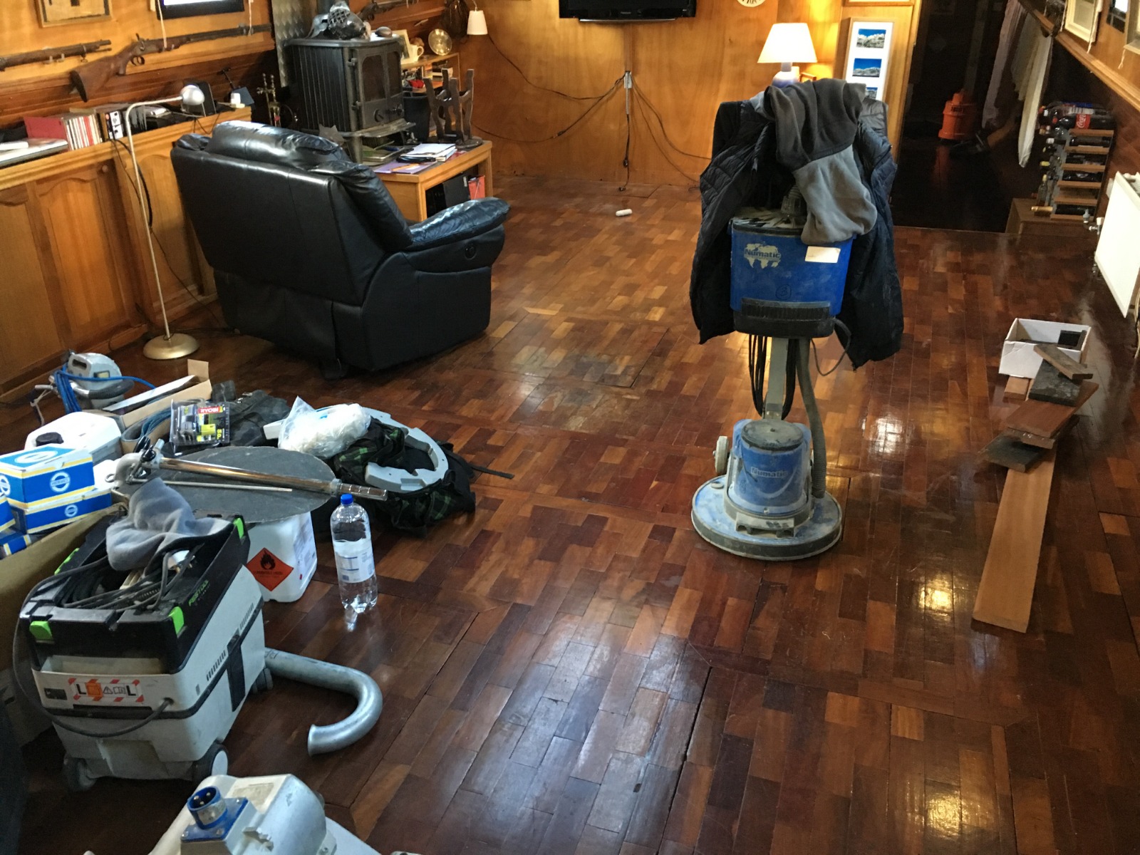 Commercial Floor Sanding in Kent – preparation work on a dark hardwood parquet block floor with sanding machines and equipment ready for restoration.