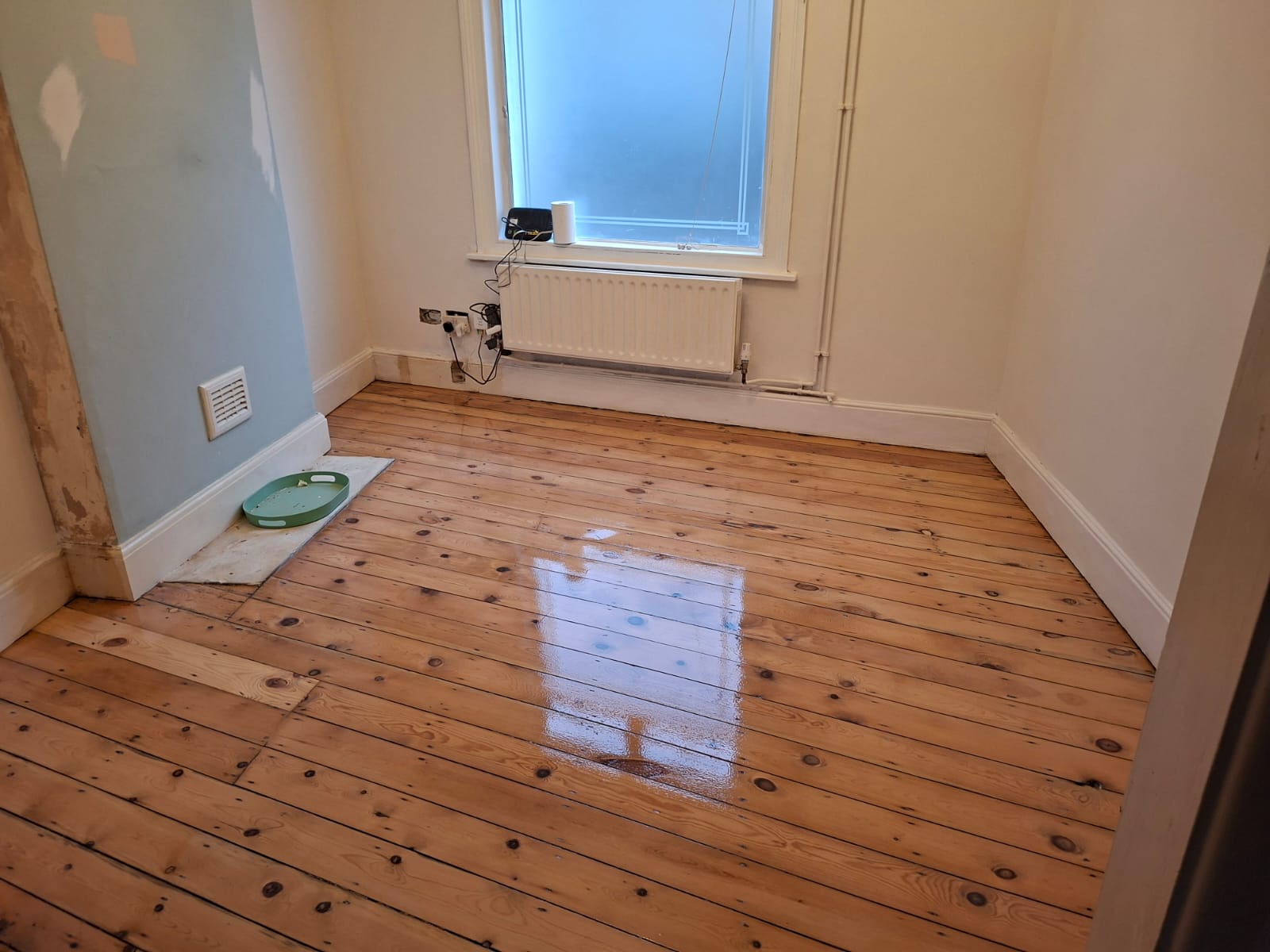 Wood Floor Sanding in Kent on original pine floorboards, showing a small bedroom with freshly sanded and lacquered solid pine wood floor.