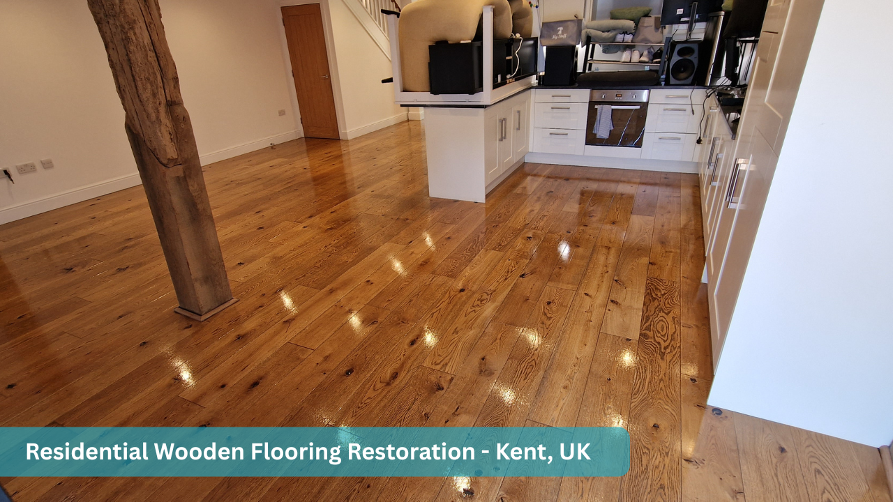 Restored residential oak wooden floor in a modern open-plan kitchen and living area in Kent, UK, featuring a rich satin finish and natural timber grain.